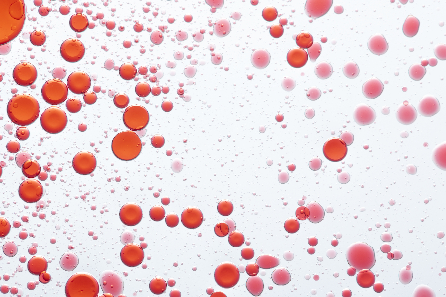 macro image of red oil droplets in water