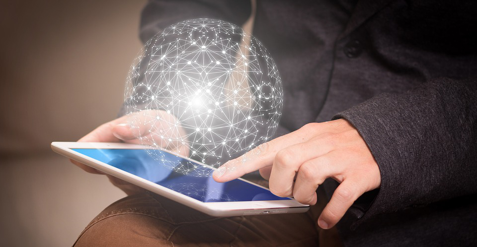 Imaginative image with a portable computer and a round network hologram.