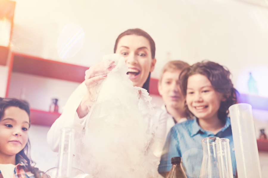 woman expressing positivity while doing experiment with children