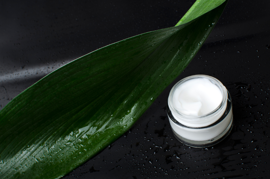 Opened glass container of facial cream